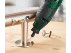 A rotary tool with a polishing attachment is used on a metal railing, with wire brushes nearby.