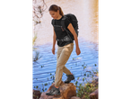 Hiking boots and backpack by the water.