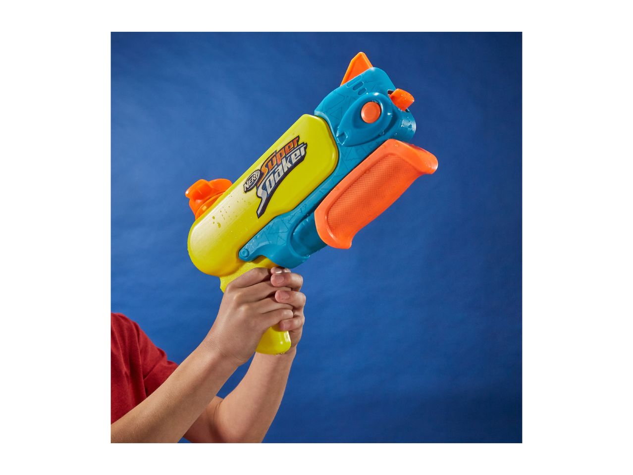 Child's hands holding a yellow and blue water blaster with orange accents against a blue background.