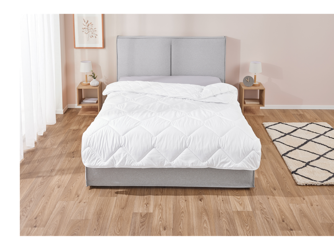 A fluffy white duvet on a modern bed.