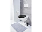 Modern bathroom with a wall-mounted toilet, black seat, and gray bath mat.