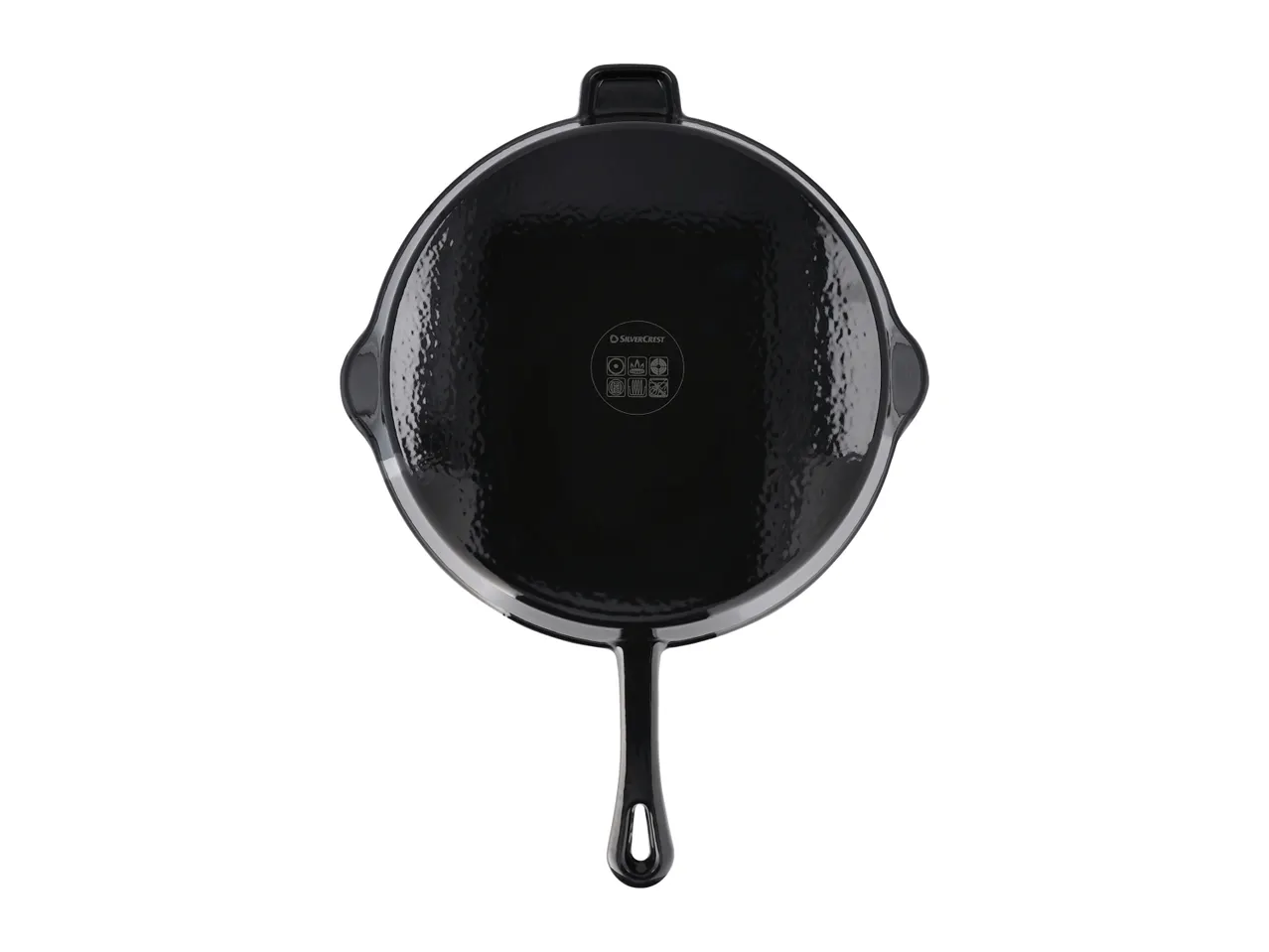 A black SilverCrest cast iron pan with a textured surface and a long handle.