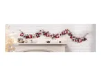 Christmas advent calendar garland with numbered fabric bags, festive decorations on a mantelpiece.