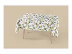 White tablecloth with a vibrant lemon and leaf pattern on a wooden table.