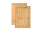 Two light brown bamboo cutting boards with juice grooves, stacked on a white background.