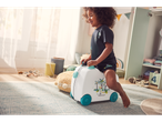 Child on a car-shaped suitcase, tropical theme.