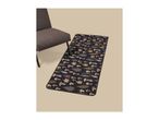 A dark runner rug with a mushroom and leaf pattern next to a brown chair.