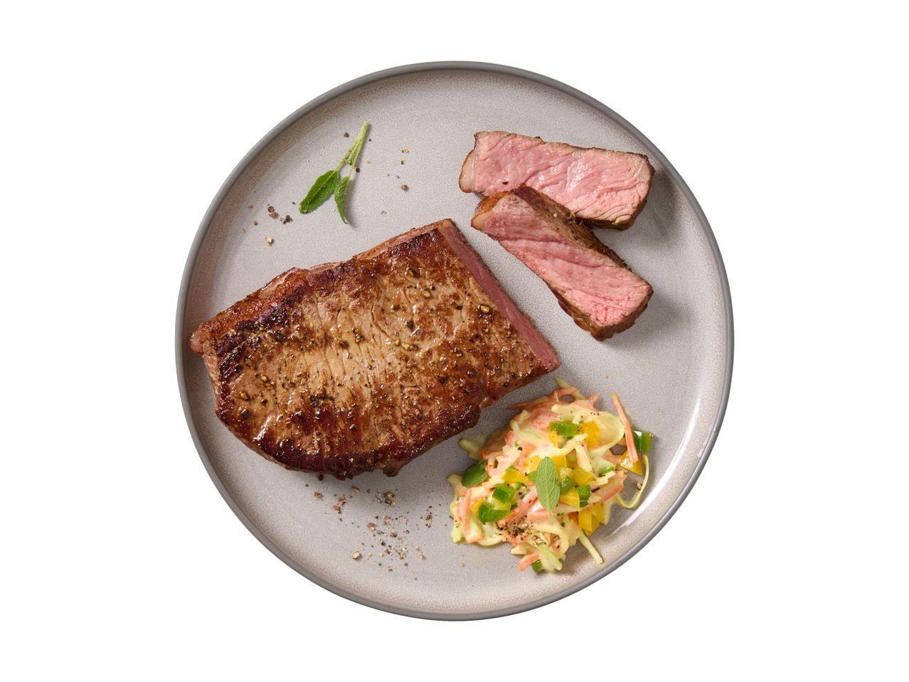 Cooked steak with a side of coleslaw on a plate.
