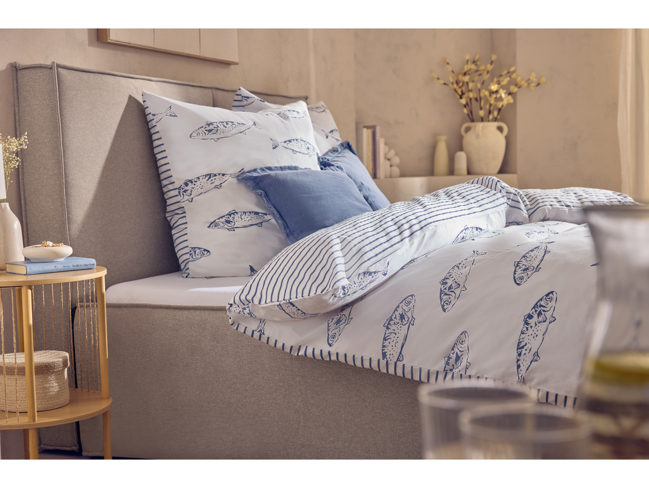 Bedroom with Livarno Jersey Fitted Sheet, fish-patterned duvet, and blue pillows.