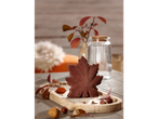Autumnal decorations featuring a maple leaf, nuts, and fall foliage on a wooden tray.