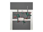 A set of green and red bar clamps of various sizes, holding white wooden frames.