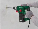 A worker uses a Parkside SDS-max demolition hammer to remove mortar from a wall.