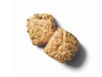 Two whole-wheat rolls with pumpkin seeds.