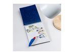 A Paw Patrol spiral notebook with a water pen, showing colorful designs on a white surface.