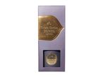 Reed diffuser in purple packaging with gold details