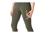 Woman in olive green capri leggings with a neon green zippered pocket.