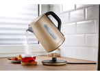 Gold SILVERCREST® kettle pouring hot water into a cup of tea.