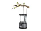 Grey camping lantern with LED lights hanging from a tree branch with green leaves.