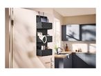 Three-tier dark grey hanging organizer mounted on a door in a kitchen setting.