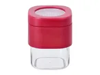 Red and clear square spice grinder with a textured grinding mechanism.