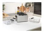 Salter deep fat fryer with three baskets on a kitchen counter with potatoes.