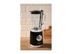 Retro-style black blender with a glass jug on a wooden countertop