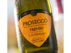 Chilled bottle of Allini Prosecco Treviso, with condensation and an orange label.