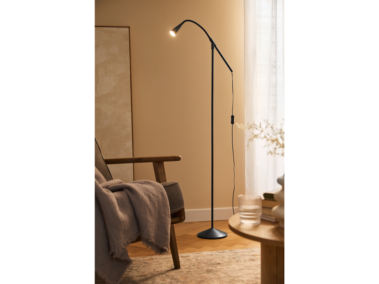 Luminária de chão moderna com pescoço flexível em uma sala de estar.