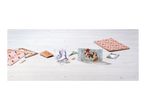 Craft supplies including patterned paper, scissors, glue, and a pop-up card on a wooden table.