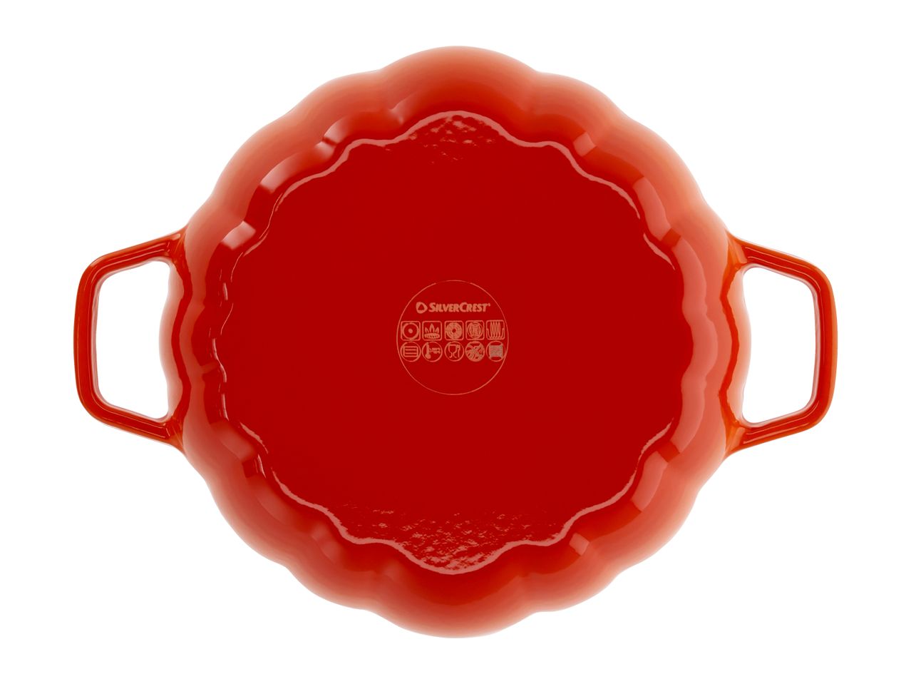 Bottom view of a red, pumpkin-shaped cast iron casserole dish with handles