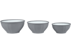 Three gray mixing bowls of varying sizes with a white interior