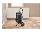 A black shopping cart with a thermal bag stands on a light brown wooden floor.