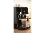 Automatic coffee machine with a latte macchiato, coffee beans, and sugar on a wooden counter.