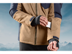 Man in Crivit ski jacket putting card into sleeve pocket.
