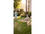 Happy children playing with Lupilu sand toys and a water gun in a sunny garden.