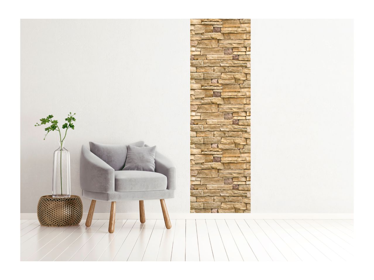 Modern living room with a gray armchair, a plant in a vase, and a stone accent wall.