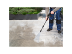 A worker cleans a patio with a Kärcher pressure washer.