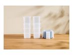 Two stacks of clear plastic food containers next to a stack of matching blue-rimmed lids.