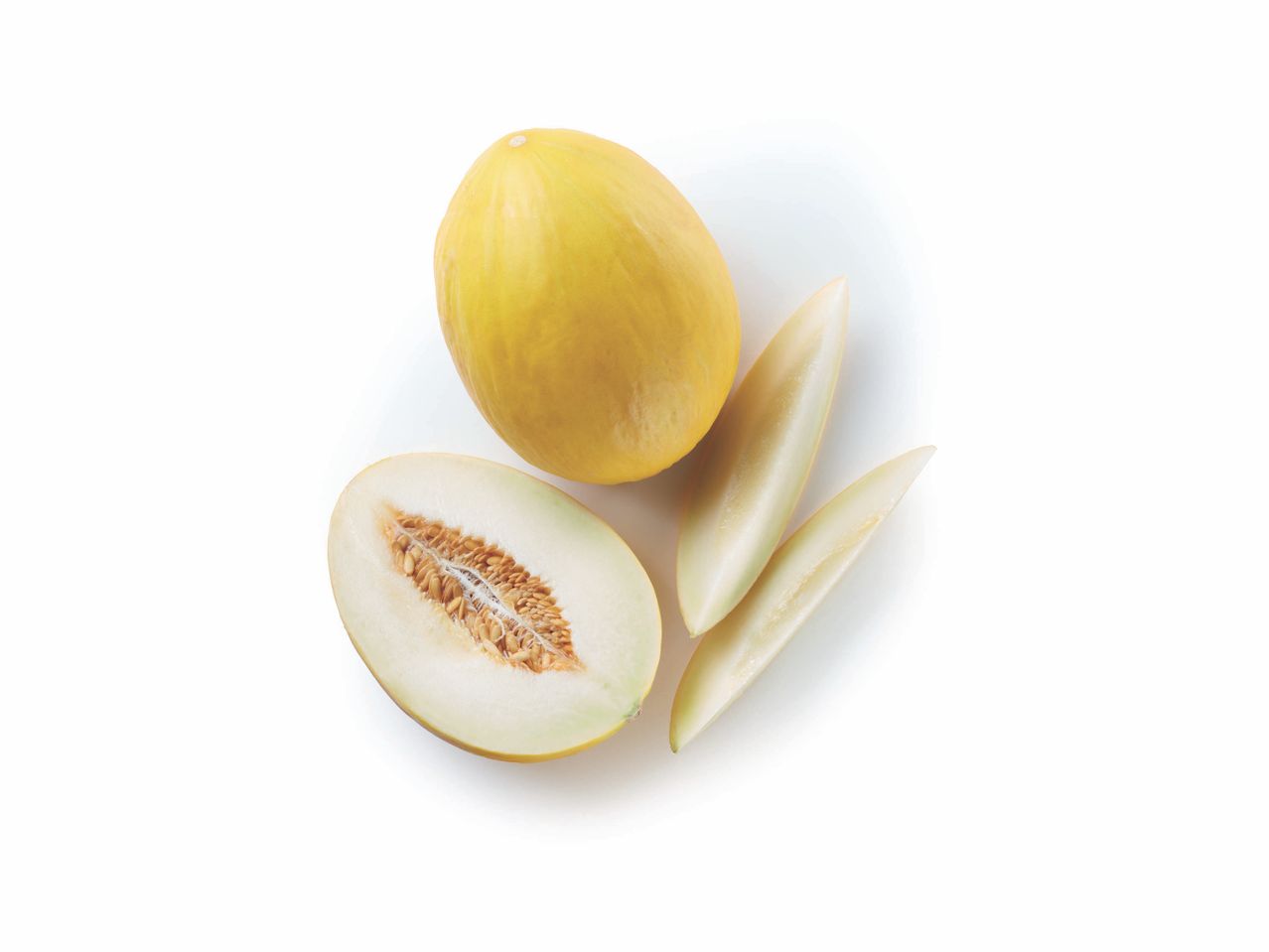 A whole and a sliced yellow honeydew melon with some leaves.
