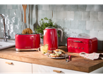 SILVERCREST® red kettle, toaster, and bread box on a kitchen counter with breakfast.