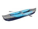 Blue and grey inflatable kayak with a paddle, viewed from an angle.