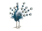 Decorative metal peacock with spread tail feathers and cut-out details.