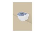 Wall-mounted toilet with a lid featuring a serene image of stacked stones and flowers.