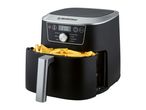 Black air fryer with a silver handle, filled with golden french fries.