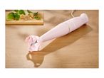 A pink SilverCrest immersion blender on a wooden surface next to basil and cheese.