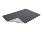A dark gray rectangular mat with one corner slightly lifted, revealing a lighter gray underside.