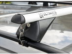 Silver roof rack with a key in the lock, mounted on a car roof.