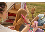 Hair straightening with a SilverCrest straightener at a festival.
