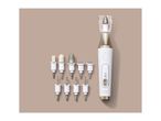 Electric manicure and pedicure device with multiple interchangeable attachments on a beige background.