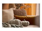 Cozy autumn living room decor with two plush pumpkin pillows and soft blankets.
